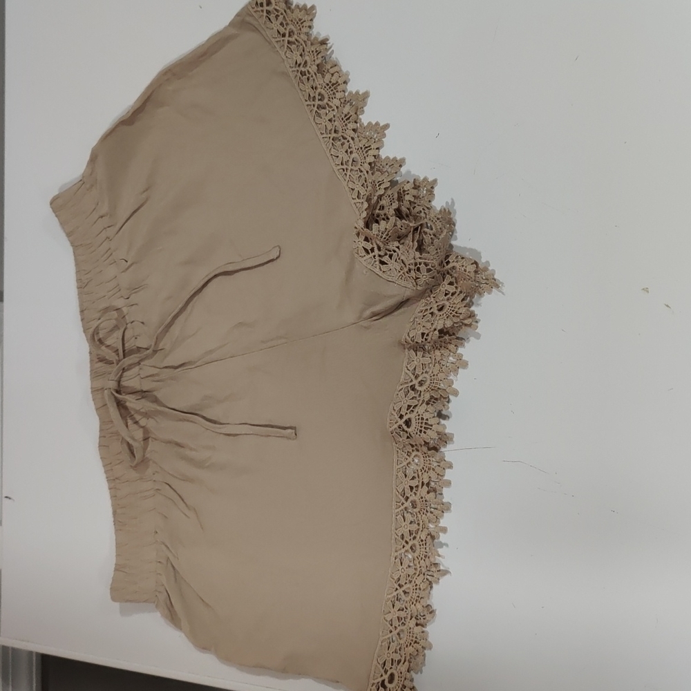 NWOT- ambiance apparel tan shorts with lace bottom. Size Large, Juniors.
